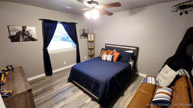 bedroom featuring hardwood / wood-style floors and ceiling fan