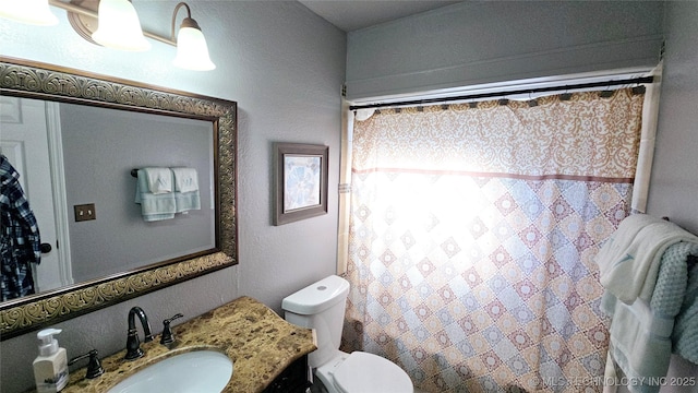 bathroom featuring vanity, toilet, and a shower with shower curtain