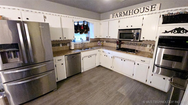 kitchen featuring white cabinetry, appliances with stainless steel finishes, and backsplash