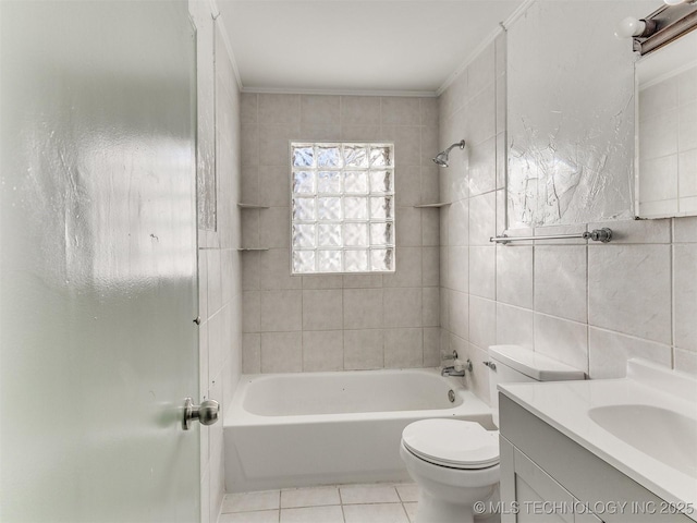 full bathroom with tiled shower / bath combo, tile patterned floors, toilet, vanity, and tile walls