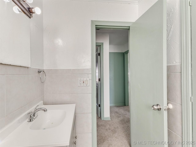 bathroom featuring vanity and tile walls