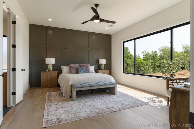 bedroom featuring light hardwood / wood-style flooring and ceiling fan