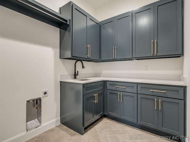 laundry room with sink, light tile patterned floors, cabinets, and hookup for an electric dryer