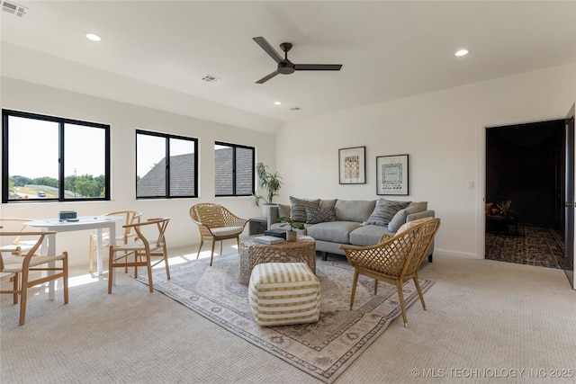 living room with ceiling fan, light carpet, and vaulted ceiling