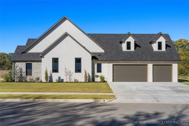 view of front of home with a front lawn and a garage