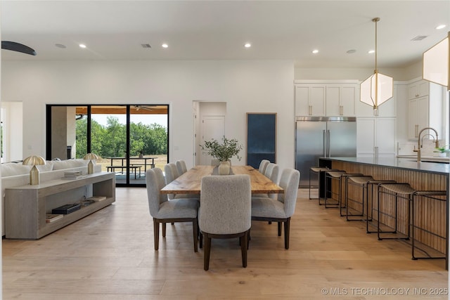 dining room with light hardwood / wood-style floors and sink