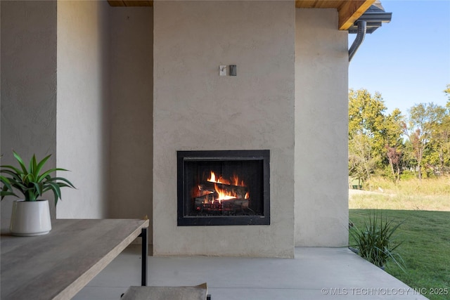 property entrance with a yard and an outdoor fireplace