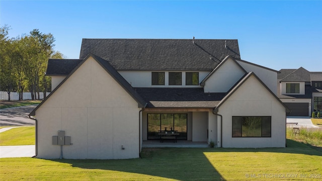 back of property with a patio area and a lawn