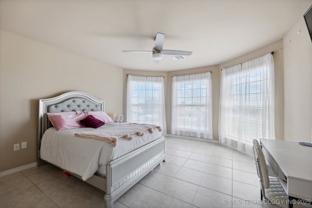 bedroom featuring multiple windows, light tile patterned floors, and ceiling fan