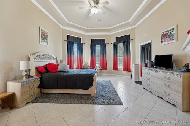 bedroom featuring ceiling fan, light tile patterned floors, crown molding, and a tray ceiling