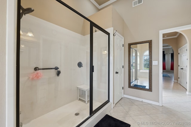 bathroom featuring tile patterned floors, crown molding, and walk in shower