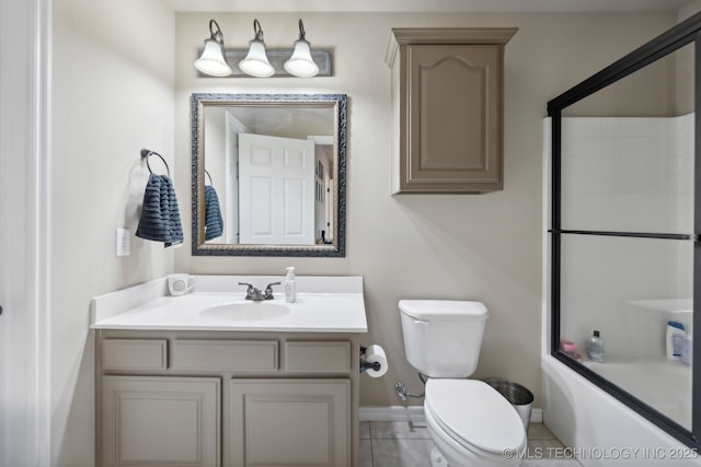 full bathroom featuring tile patterned floors, combined bath / shower with glass door, toilet, and vanity