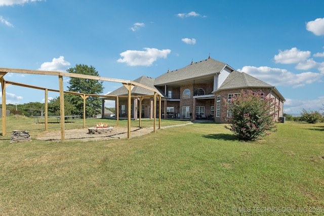 rear view of property featuring a lawn