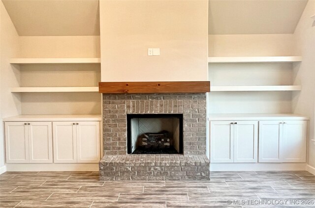 unfurnished living room with a brick fireplace