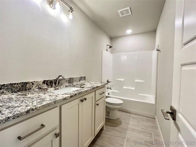 full bathroom with shower / tub combination, vanity, and toilet