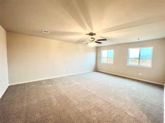 spare room with ceiling fan and carpet