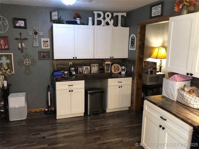 kitchen featuring tasteful backsplash, dark hardwood / wood-style flooring, and white cabinets