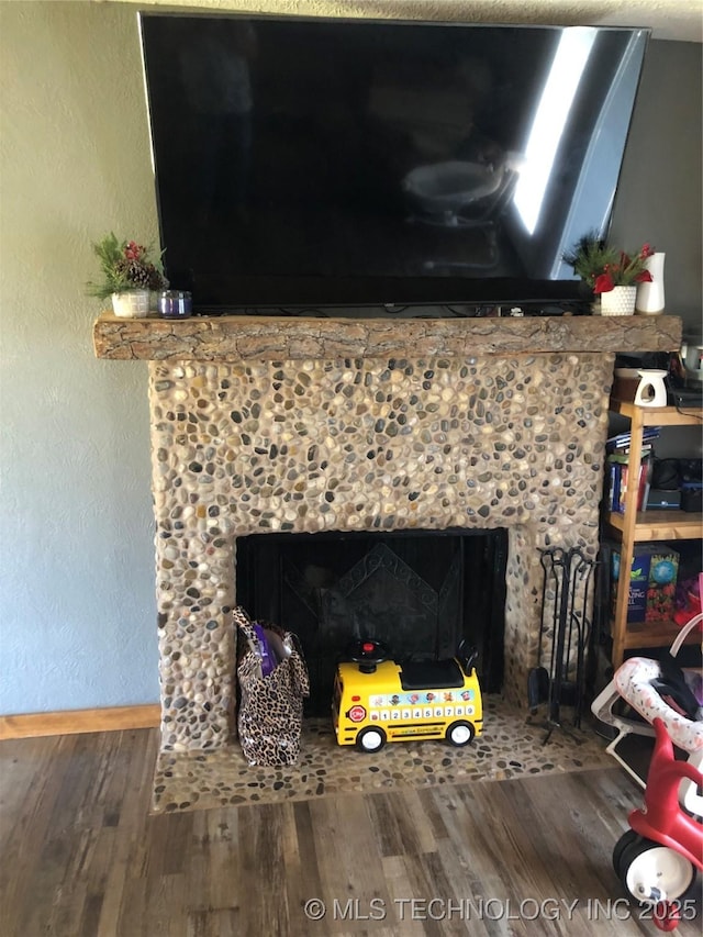 details with a fireplace and hardwood / wood-style flooring