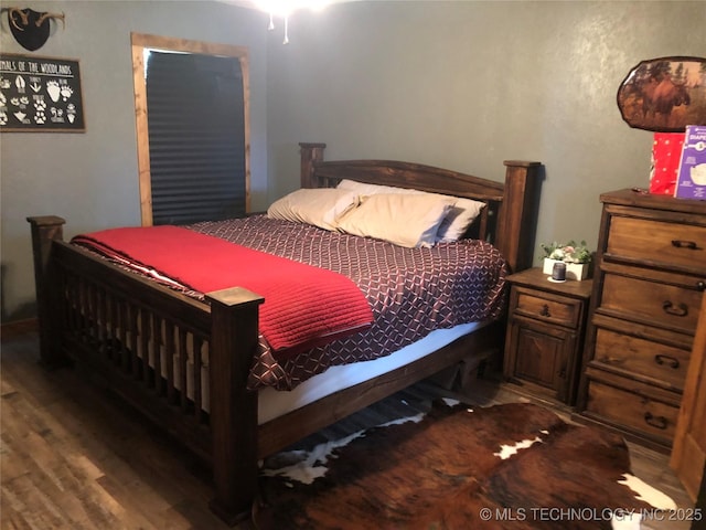 bedroom featuring dark wood-type flooring