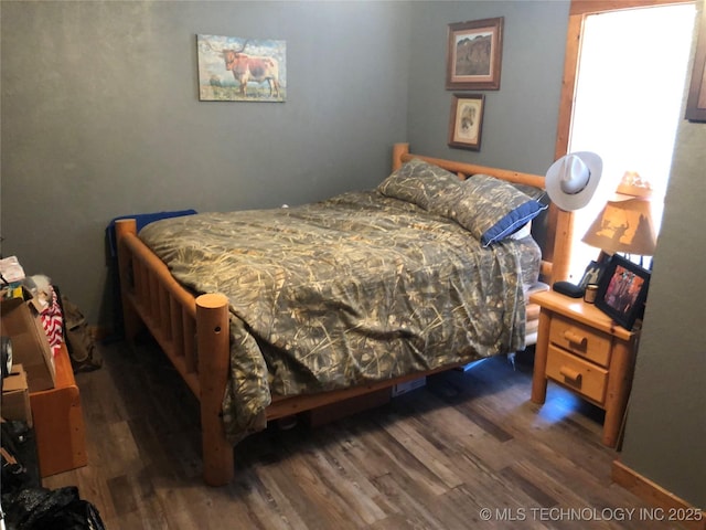 bedroom featuring dark wood-type flooring