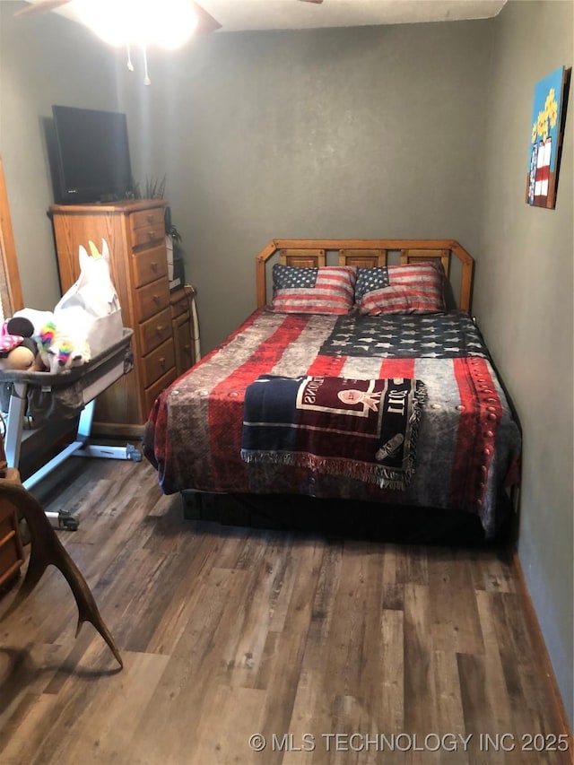 bedroom featuring hardwood / wood-style flooring and ceiling fan