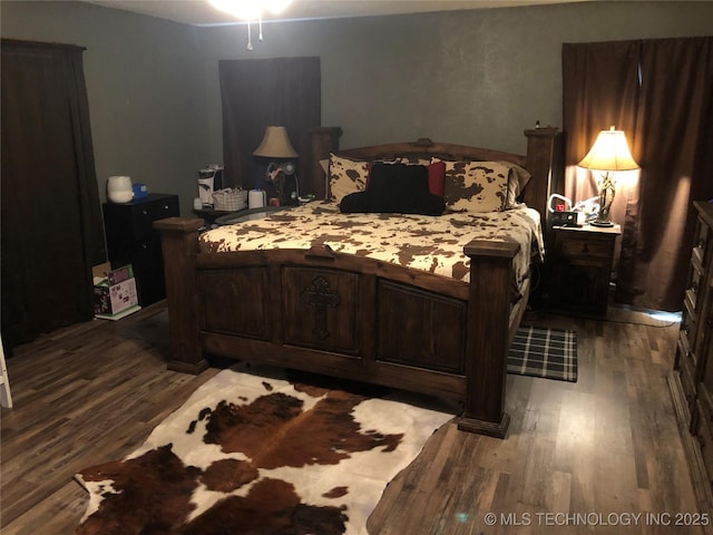 bedroom with dark wood-type flooring