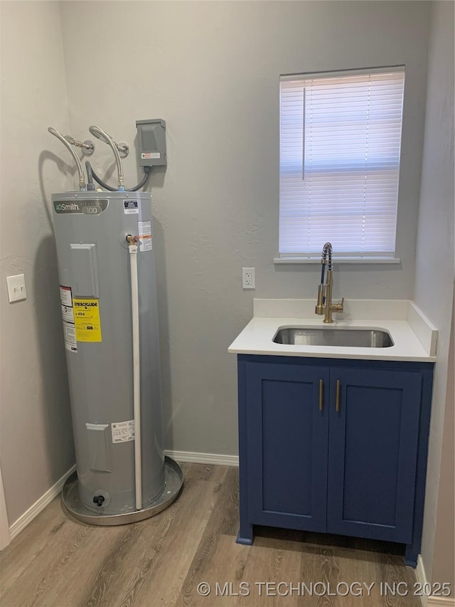 utility room featuring water heater and sink