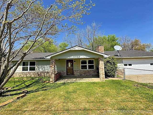 ranch-style home with a front lawn, a porch, and a garage