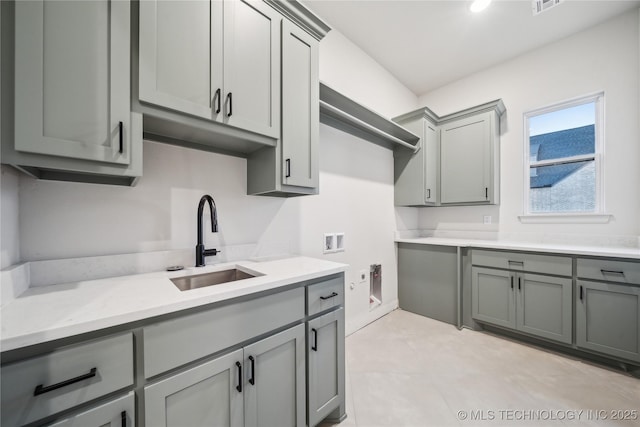 washroom featuring visible vents, a sink, washer hookup, and cabinet space