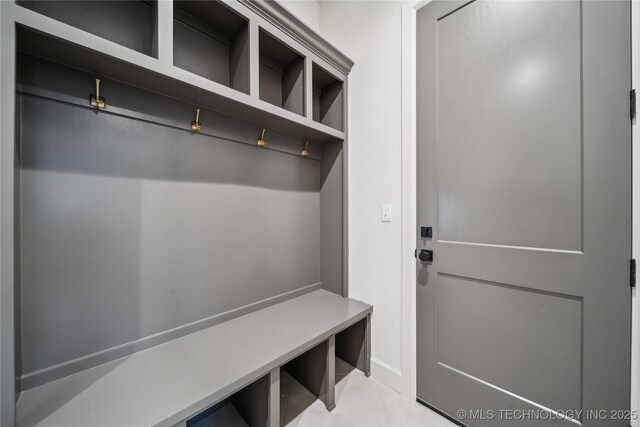 mudroom with baseboards and light tile patterned floors