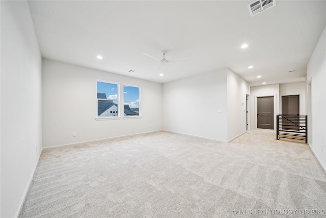 empty room with light colored carpet, a ceiling fan, visible vents, and recessed lighting
