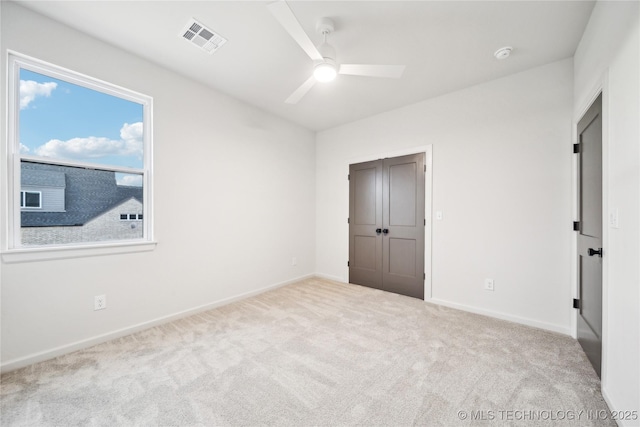unfurnished bedroom with baseboards, carpet flooring, visible vents, and a closet
