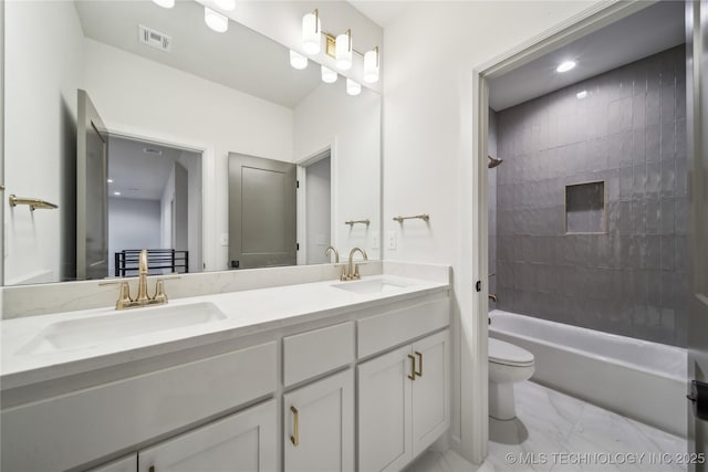 bathroom featuring a sink, marble finish floor, double vanity, toilet, and visible vents