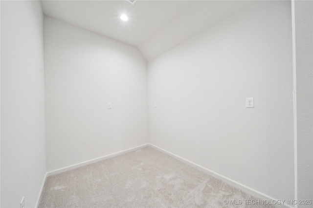 spare room featuring recessed lighting, vaulted ceiling, carpet, and baseboards