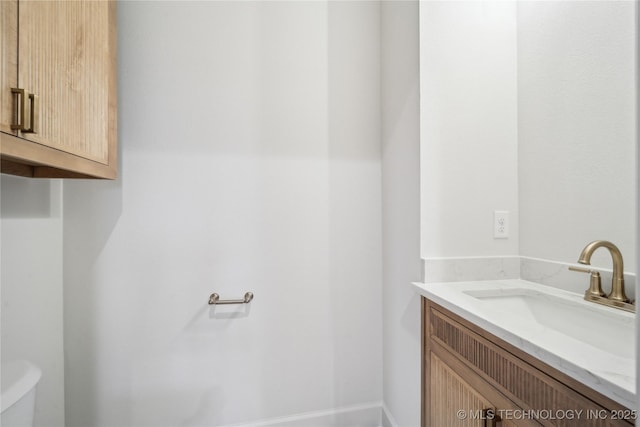 bathroom featuring toilet and vanity