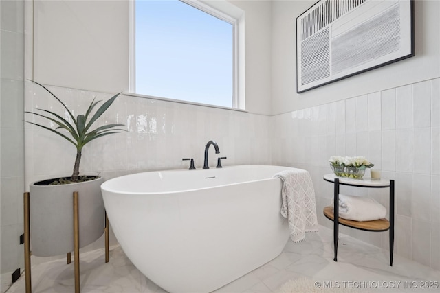 2509 E 134th Cir, Bixby, OK 74008 - full bath featuring marble finish floors, a freestanding bath, and tile walls