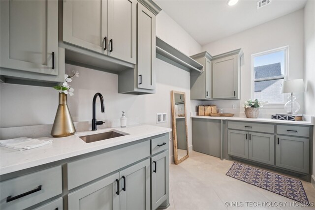 2509 E 134th Cir, Bixby, OK 74008 - kitchen featuring gray cabinetry and light countertops