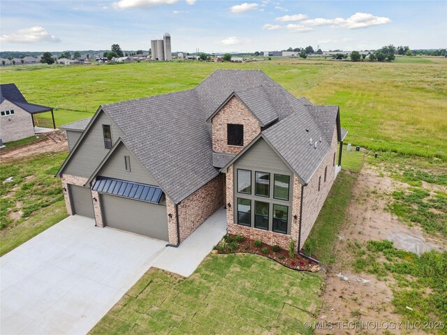 2509 E 134th Cir, Bixby, OK 74008 - view of front facade with brick siding, a garage, driveway, roof with shingles, and a front lawn