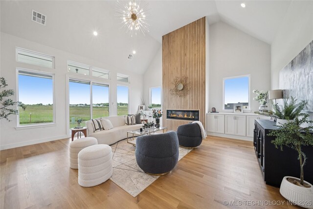 2509 E 134th Cir, Bixby, OK 74008 - living area featuring high vaulted ceiling, light wood-style flooring, a fireplace, and recessed lighting