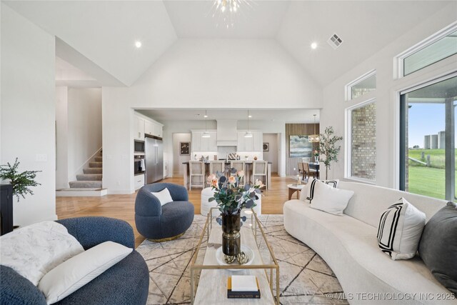 2509 E 134th Cir, Bixby, OK 74008 - living area featuring high vaulted ceiling, stairway, light wood-style floors, and recessed lighting