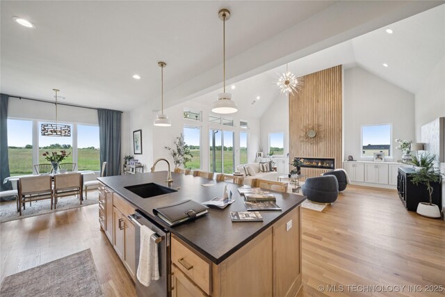 2509 E 134th Cir, Bixby, OK 74008 - kitchen featuring high vaulted ceiling, dark countertops, open floor plan, recessed lighting, and light wood-type flooring