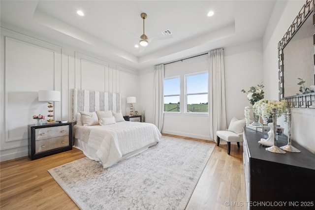 2509 E 134th Cir, Bixby, OK 74008 - bedroom with a raised ceiling, light wood-type flooring, and recessed lighting