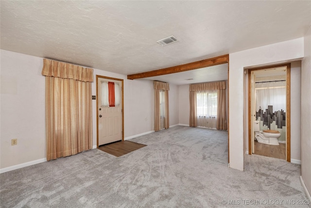 carpeted entryway featuring a textured ceiling