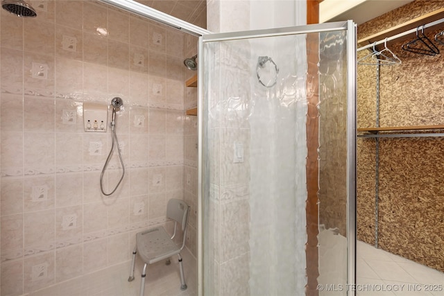 bathroom with tile patterned floors and an enclosed shower