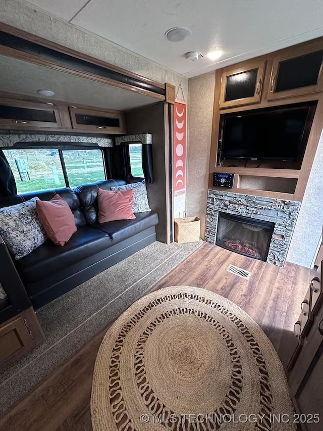 living room featuring hardwood / wood-style floors and a fireplace