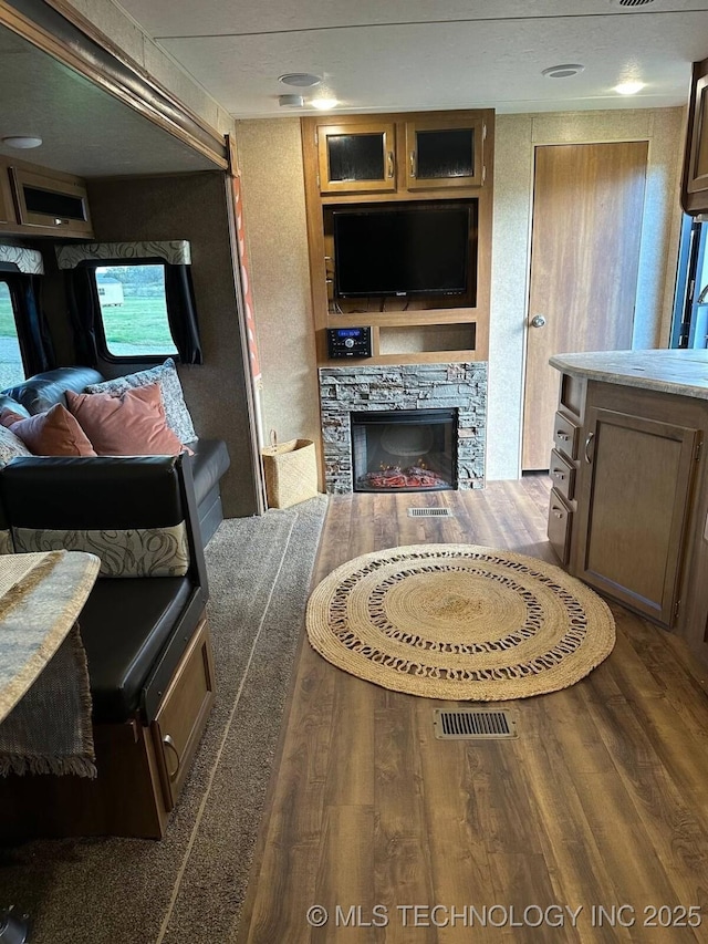 living room with dark hardwood / wood-style floors and a fireplace