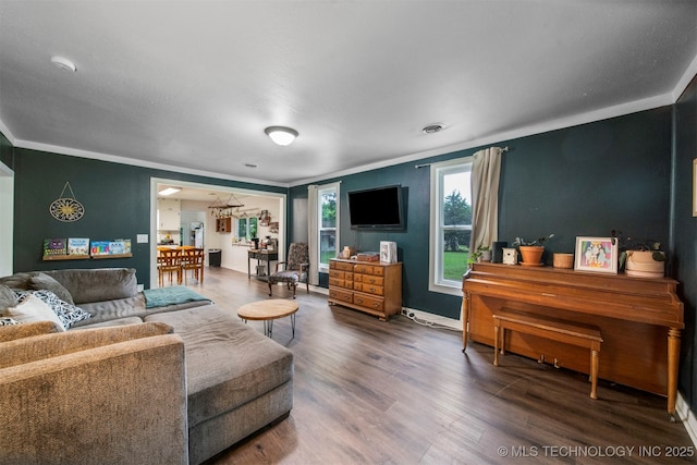 living room with dark hardwood / wood-style floors and crown molding