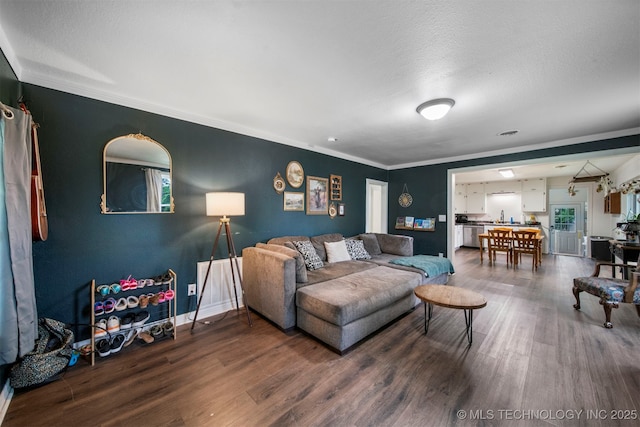 living room with hardwood / wood-style flooring, crown molding, and a textured ceiling