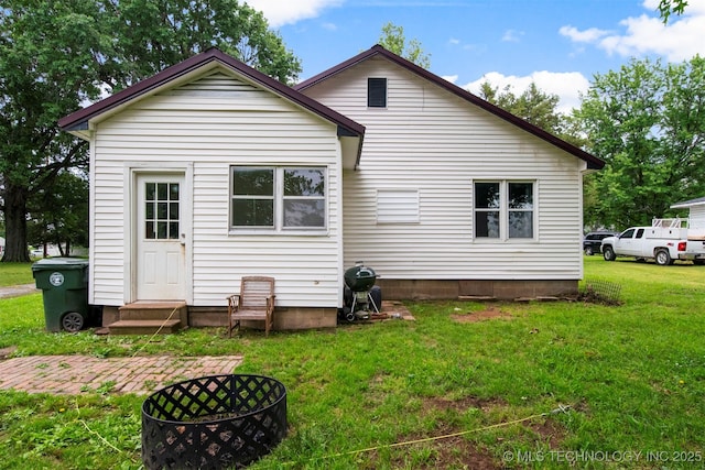 back of property featuring a yard