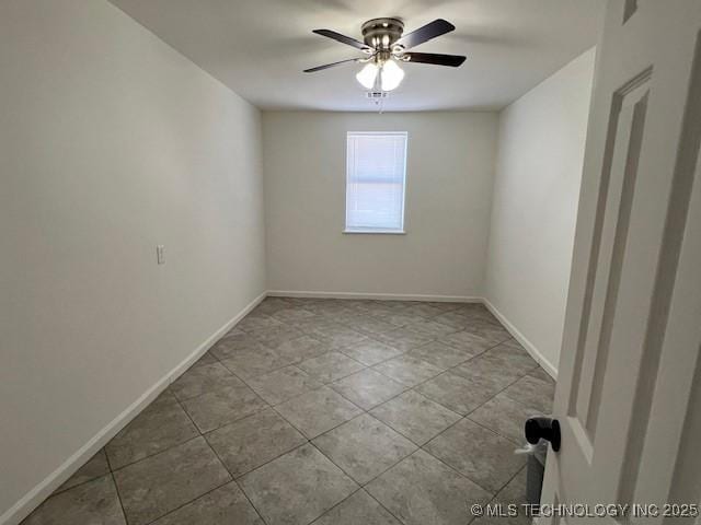 tiled spare room with ceiling fan